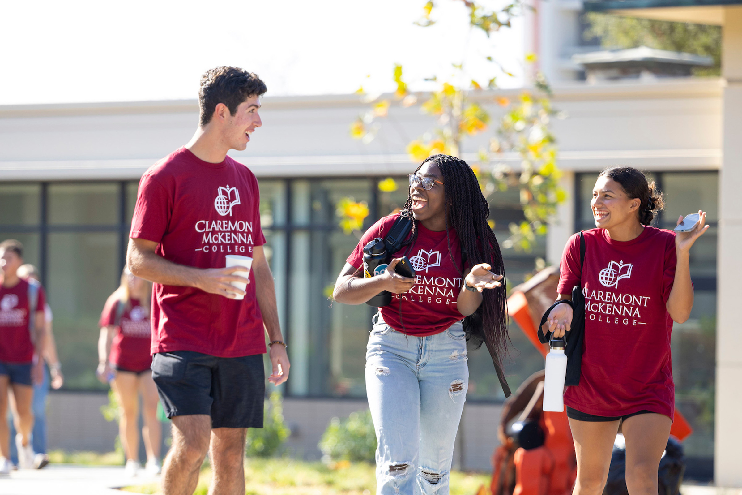 Students who arrived early to campus walk by Collins in their CMC maroon t-shirts.