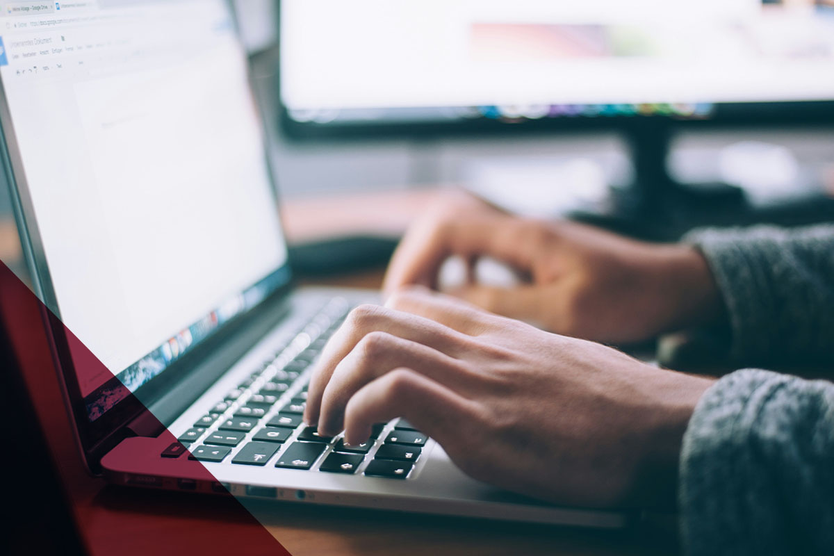 Person typing on open laptop