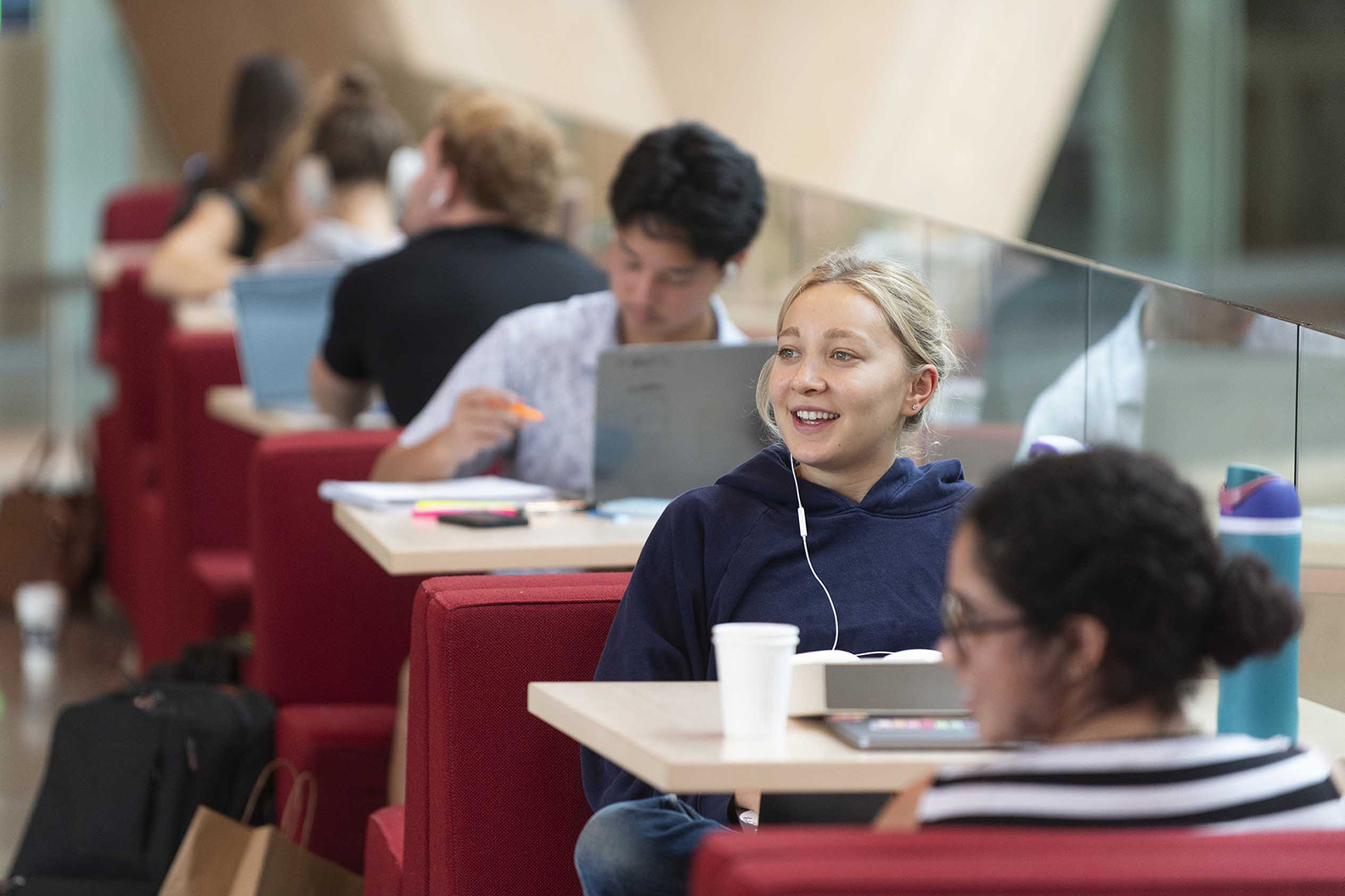 Students in booths along one of the diagonal walkways of the RDSC Atrium.