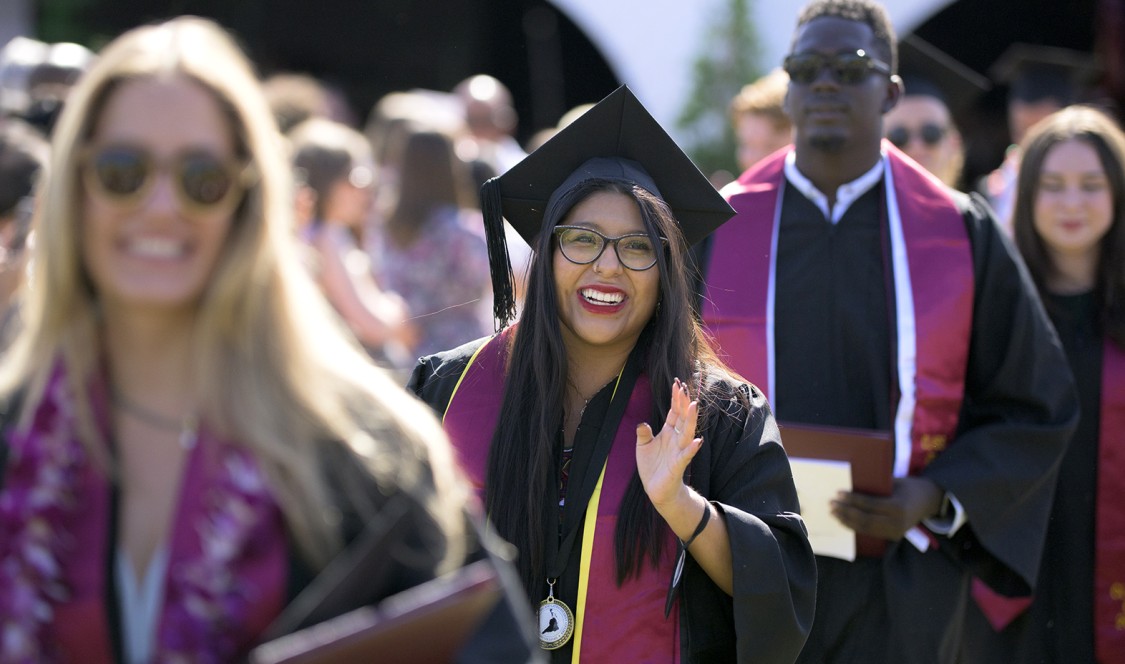 CMC soon-to-be graduates proceed into the tent, waving to families and friends along the way.