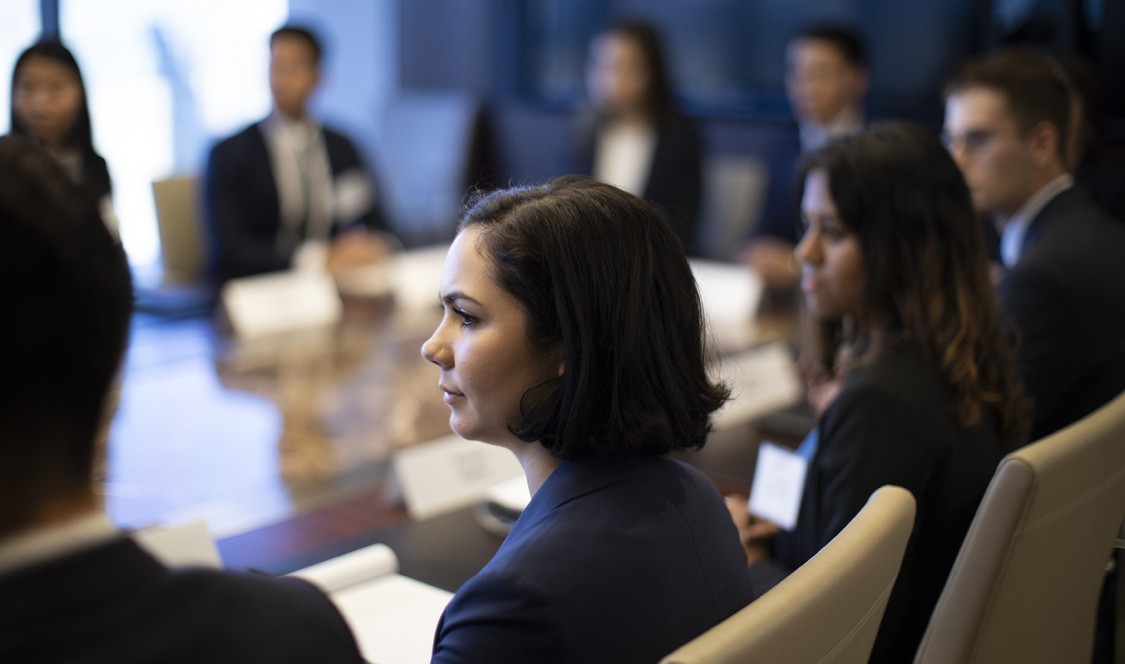 CMC students seated at a table wearing black suits to a Networking Trek with Henry R. Kravis ’67 in New York, one of many opportunities available through the campus career center.