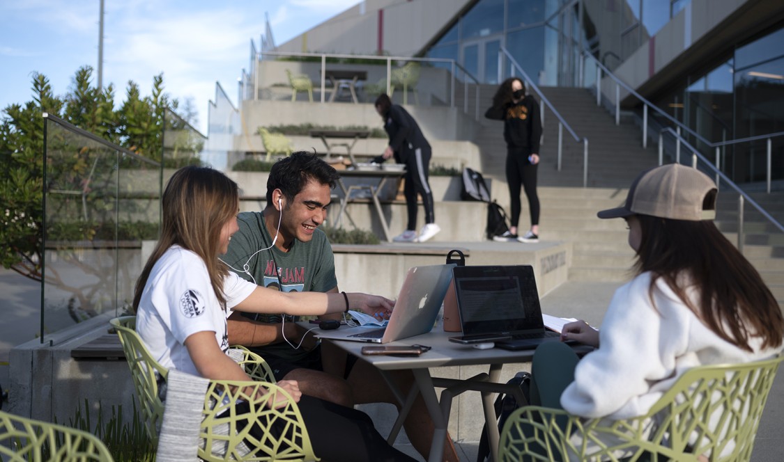 Students work together on the Colorado Terrace by Roberts Pavilion.