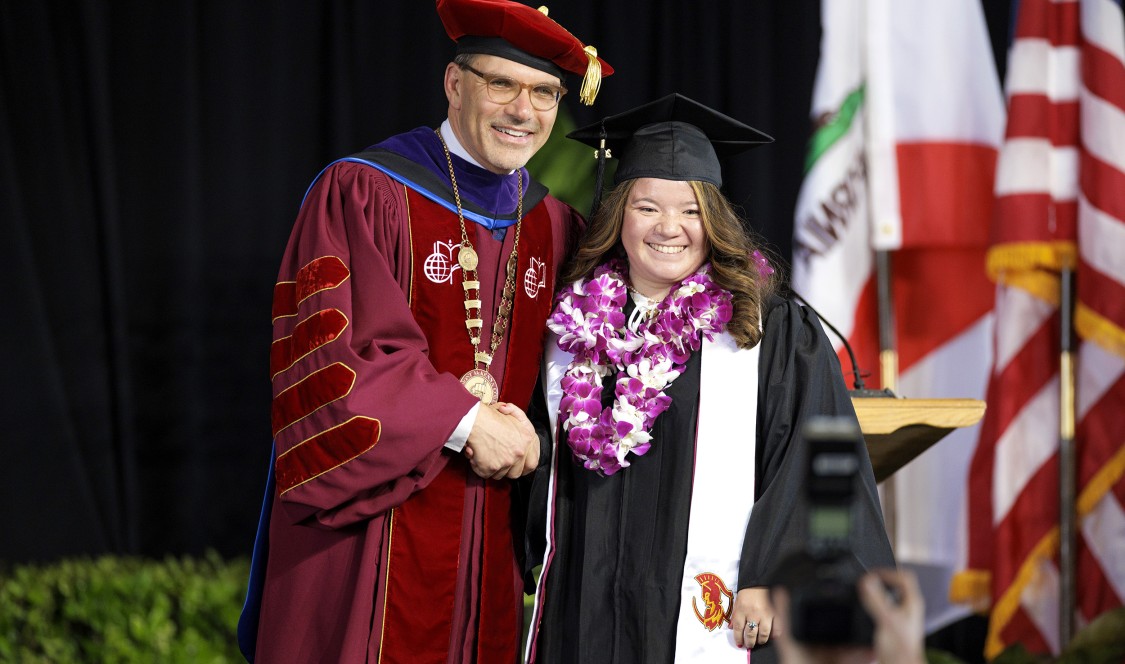 President Chodosh with a graduate.