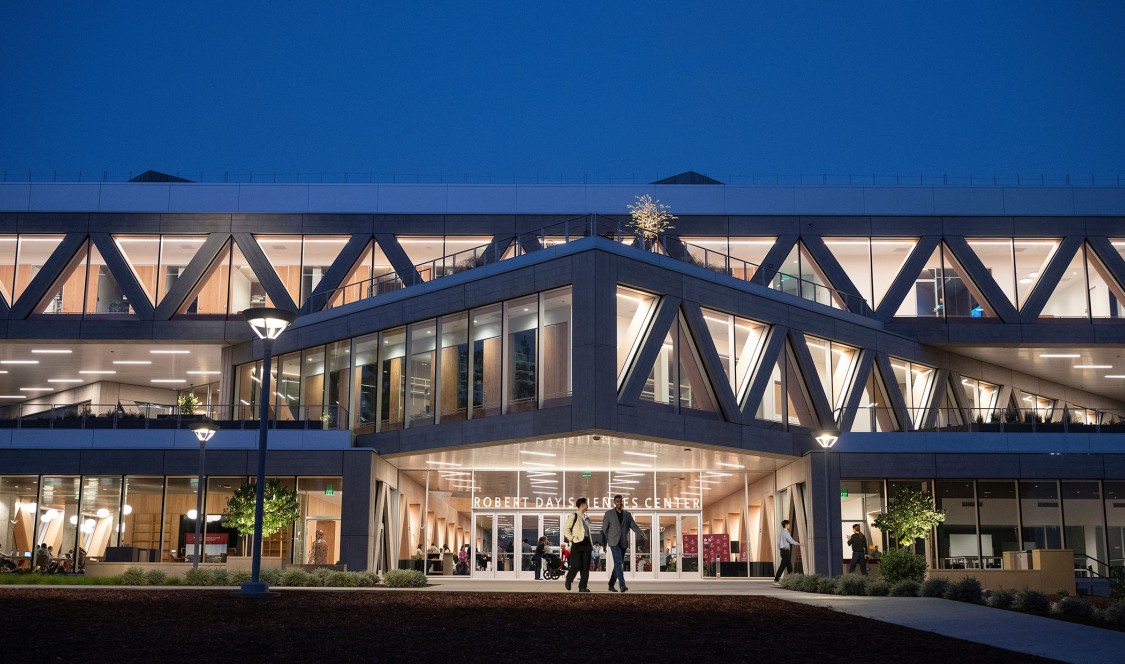 The Robert Day Sciences Center illuminated at night.