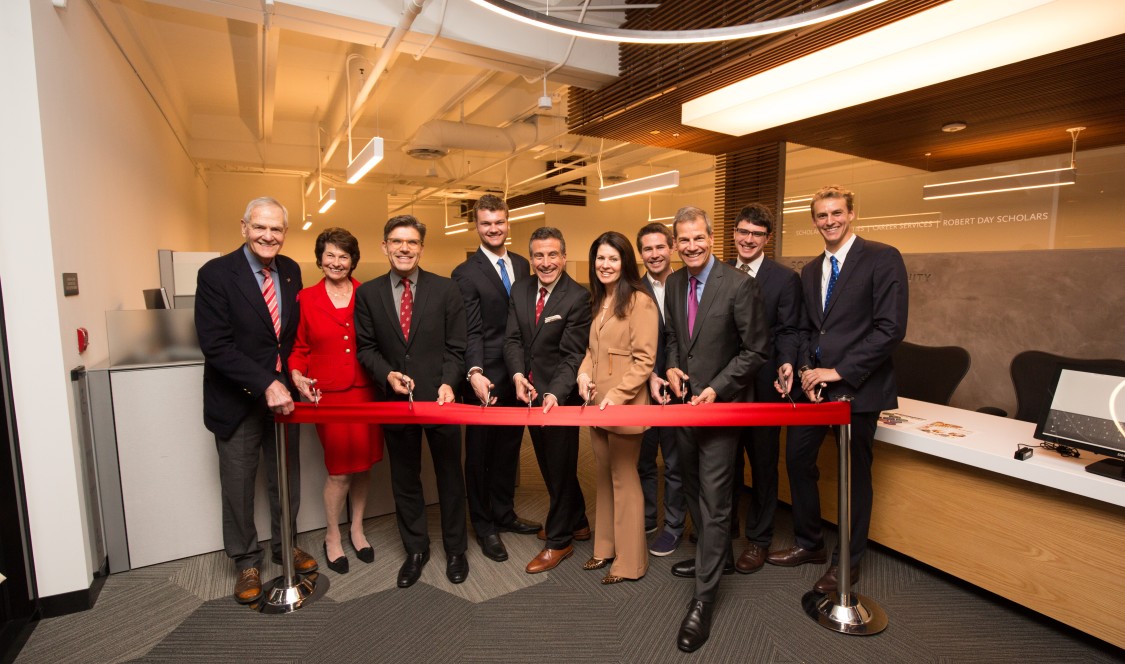Individuals gather to cut the ribbon at the Soll Center dedication.