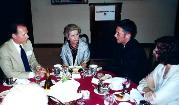 Richard Johnson ’01 sitting with President Pamela Gann and David Dreier '75