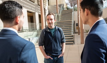 Miles Bird '13 addresses students at one of the patios outside Kravis.