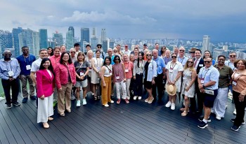 CMC Worldmeet Singapore group on building terrace.