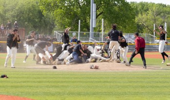 The CMS men's Baseball celebrating on the field after their victory.