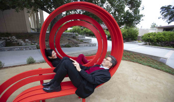 Pres. Chodosh and Priya sitting the Modified Social Benches
