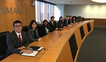 CMC students in the board room of a company in Chicago during their trip