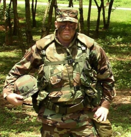 Josh Walter ’01 wearing camoflauge in a forested area.