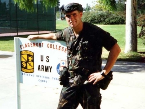 Daniel Markert ’91 standing next to Clarmeont College Army training sign.