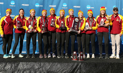 CMS Athenas Cross Country pose on the winner's podium with their NCAA runner-up trophy.