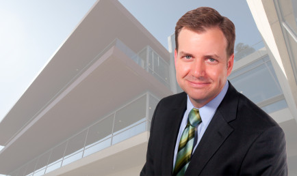 Photo collage of Ryder Todd Smith ’96 against a background of an up shot of the Kravis Center.