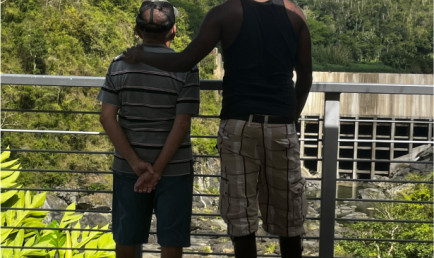 Two men looking out at the outdoors.