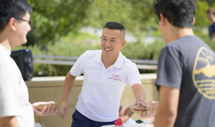 Jimmy Doan talking with students on campus