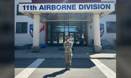 Robin Peterson ’22 in front of the Airborne Division building.