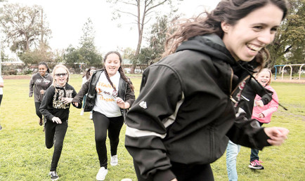 CMS softball players with elementary students