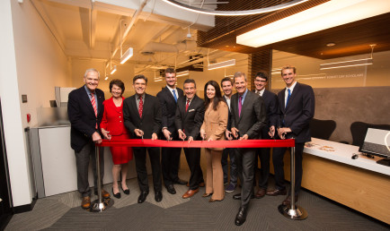 Individuals gather to cut the ribbon at the Soll Center dedication.