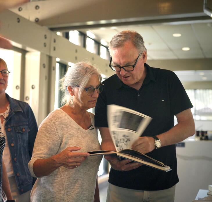 Class of 1980 classmates looking at yearbook