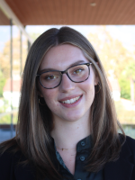 Smiling girl, named Kaylin, with glasses.